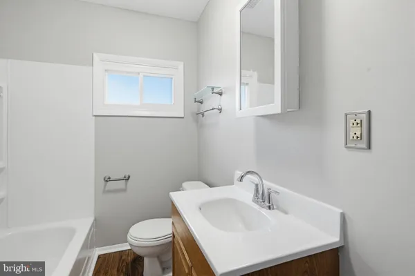 a bathroom with a sink a toilet and a bathtub