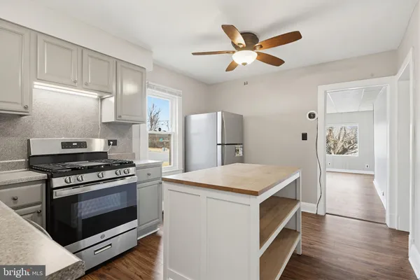 a kitchen with a stove and a refrigerator