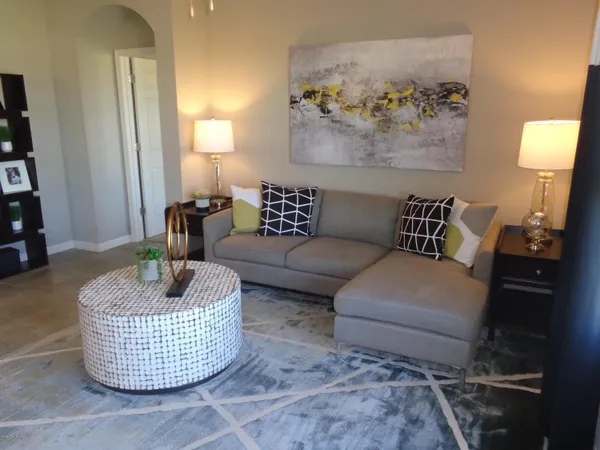 a living room with furniture and a lamp