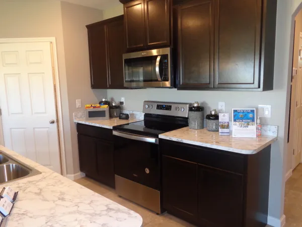 a kitchen with a sink and a microwave