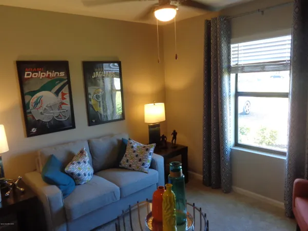 a living room with furniture and a potted plant