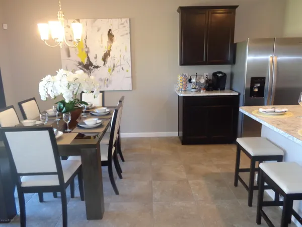 a dining room with furniture and chandelier