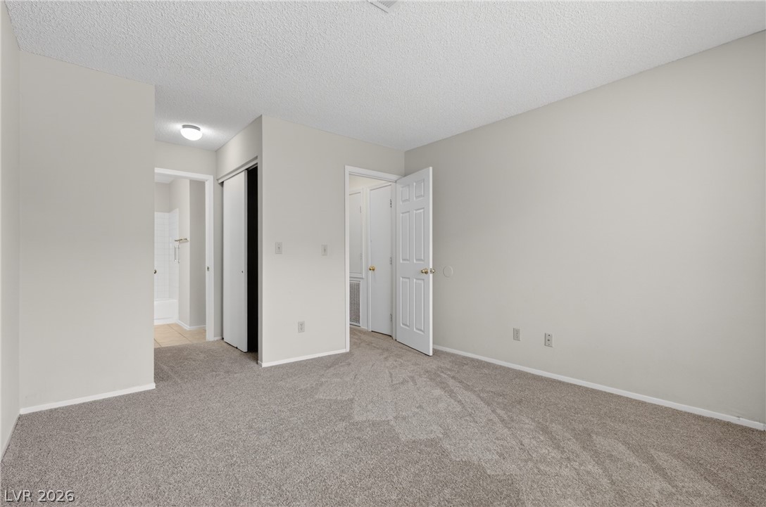 2241 Highpointe Drive, Unit 101 Laughlin, NV 89029 - Photo 14 of 23 This cozy bedroom features plush carpeting and leads to an adjoining bathroom.