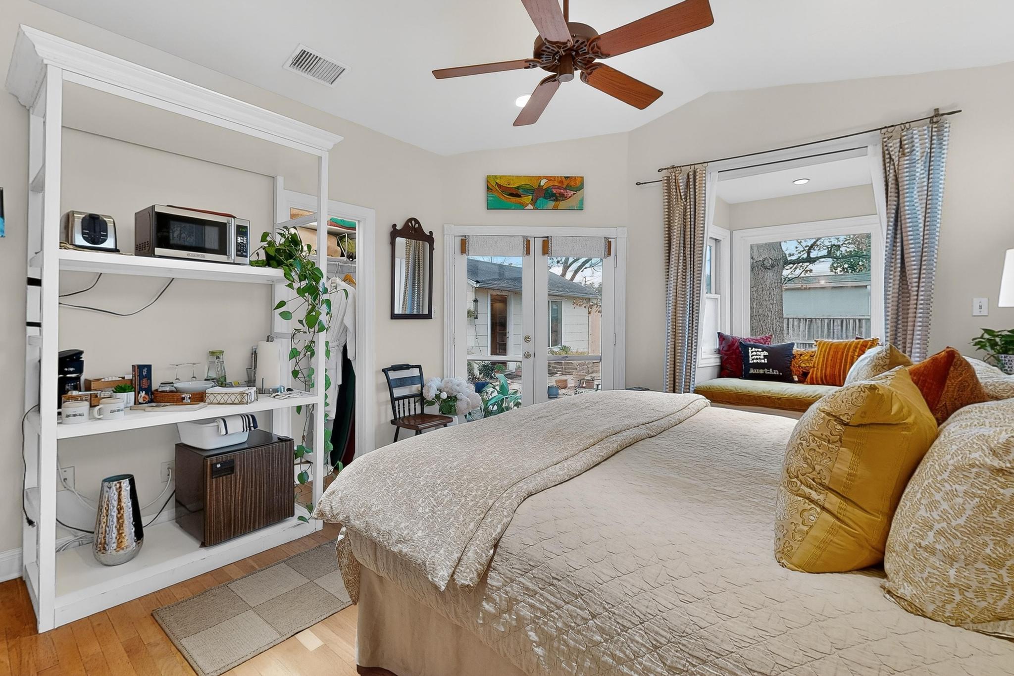 1906 Collier Street Austin, TX 78704 - Photo 15 of 40 a bedroom with a bed wooden floor and view of kitchen