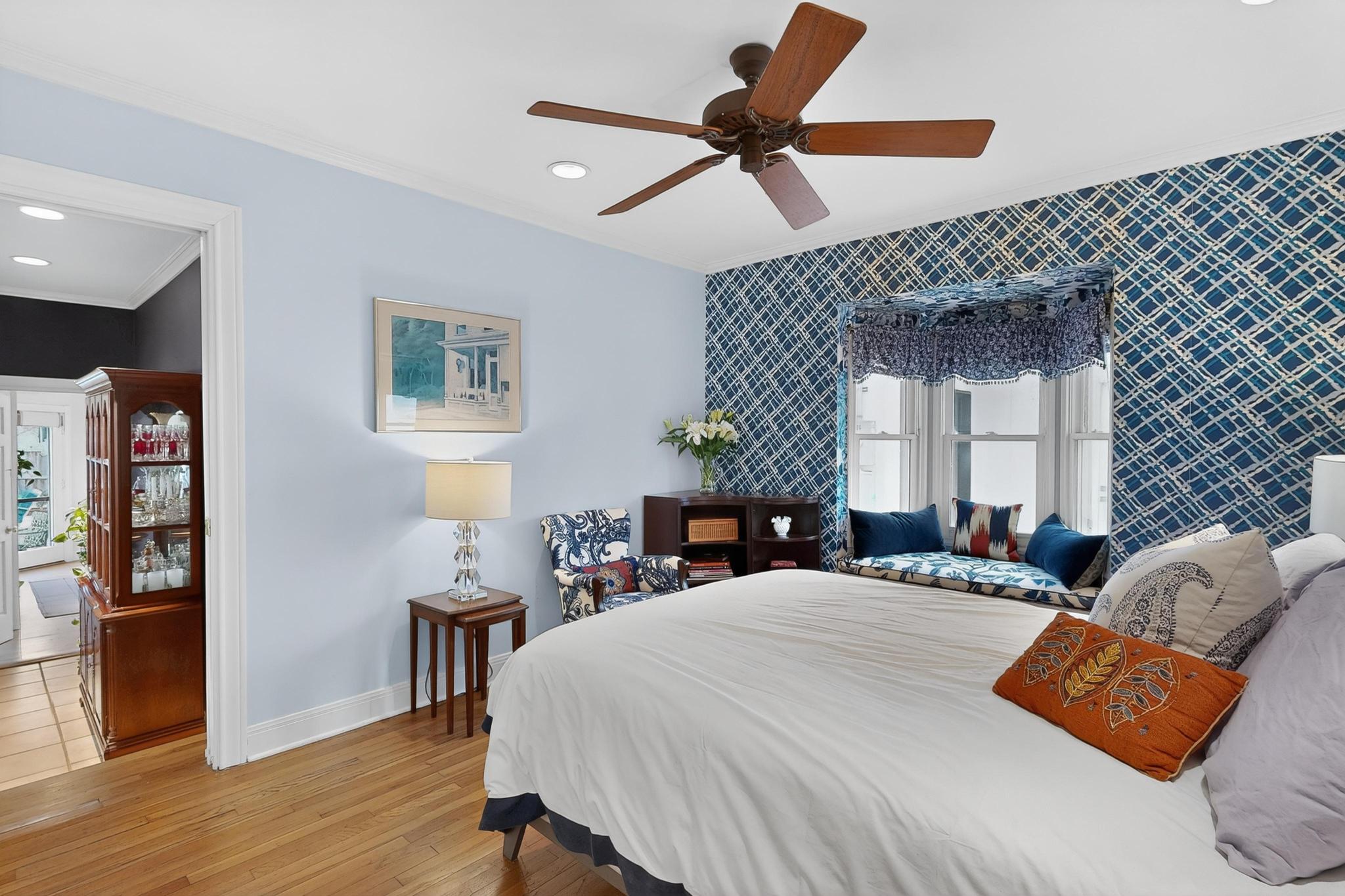 1906 Collier Street Austin, TX 78704 - Photo 21 of 40 a bedroom with a bed a dresser and a chandelier