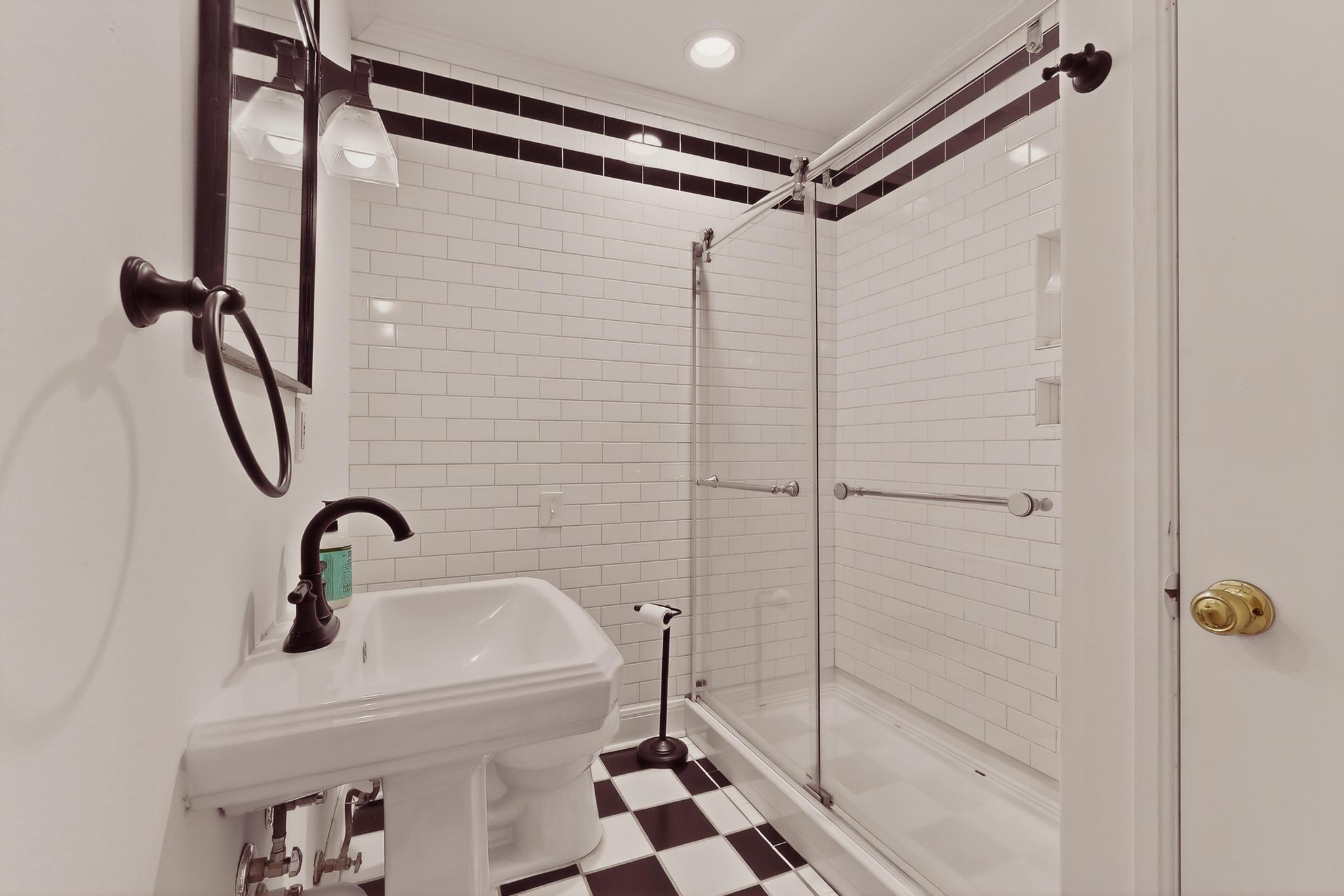 1906 Collier Street Austin, TX 78704 - Photo 23 of 40 a bathroom with a shower and mirror