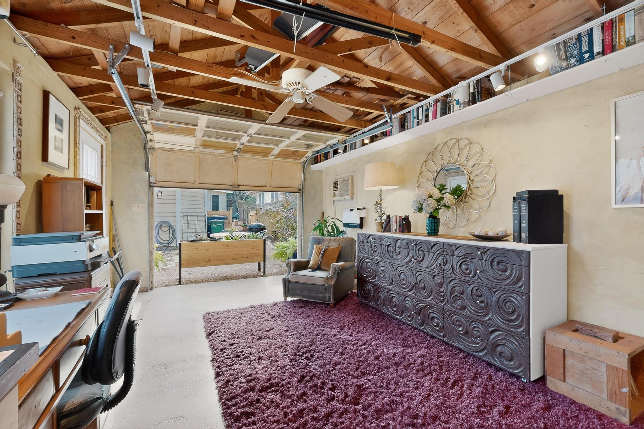 1906 Collier Street Austin, TX 78704 - Photo 27 of 40 Bonus space within this 218 sq ft garage lounge, with a wood ceiling with exposed beams and a ceiling fan.