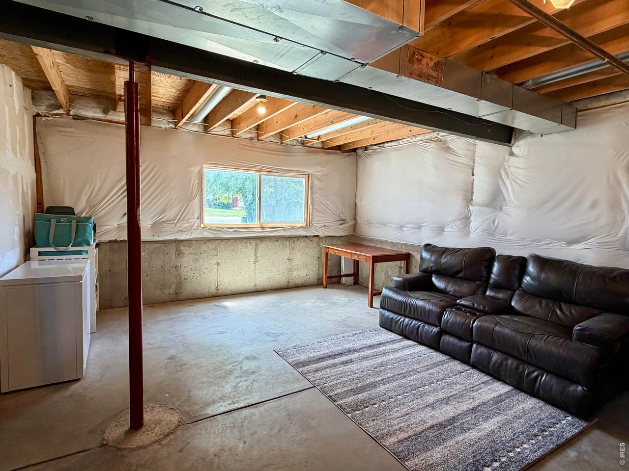233 East 19th Street Road Greeley, CO 80631 - Photo 18 of 22 a living room with furniture and a bathtub