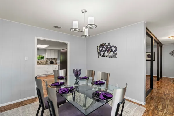 a view of a dining room with furniture and wooden floor