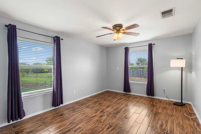a view of a livingroom with a ceiling fan and window