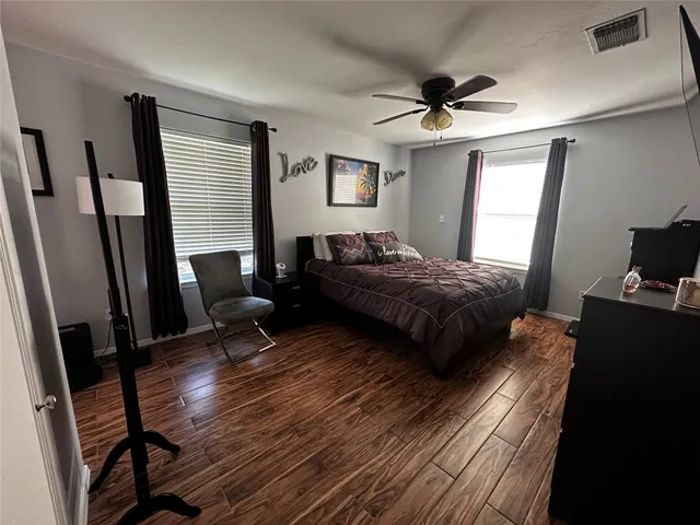 a bedroom with a bed and a mirror
