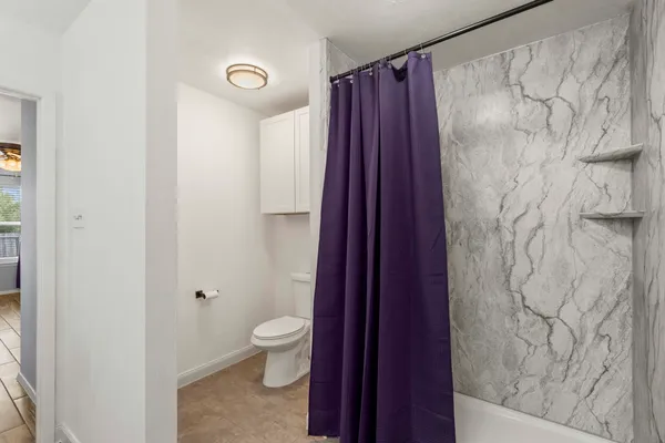 a bathroom with a shower and a toilet