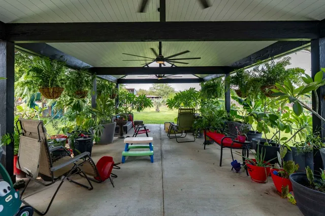 a view of a chairs and table in patio with a yard