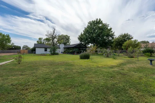 a view of a garden with a building in the background