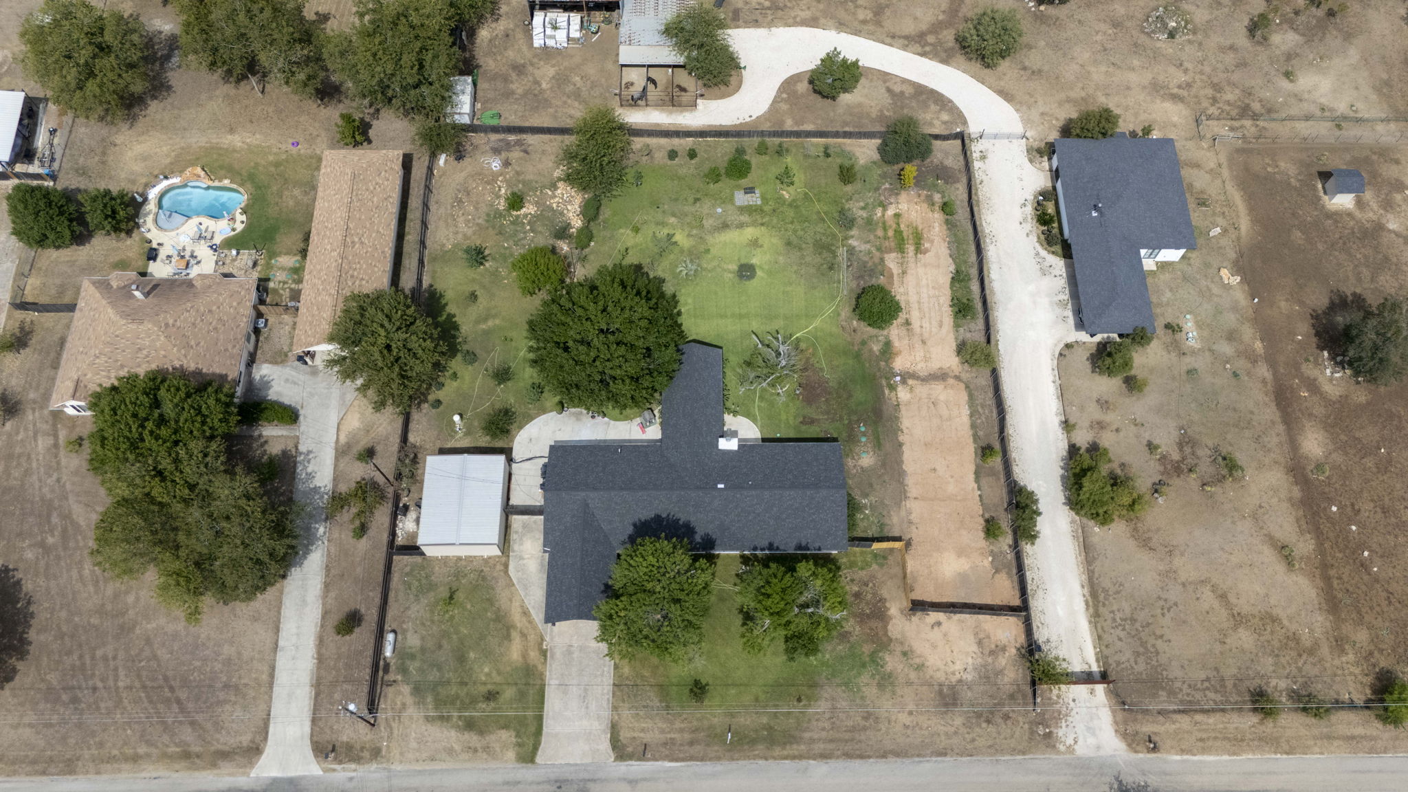 130 Hy Road Buda, TX 78610 - Photo 29 of 32 Metal building is to left of house.