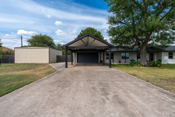 a front view of a house with a yard and a garage
