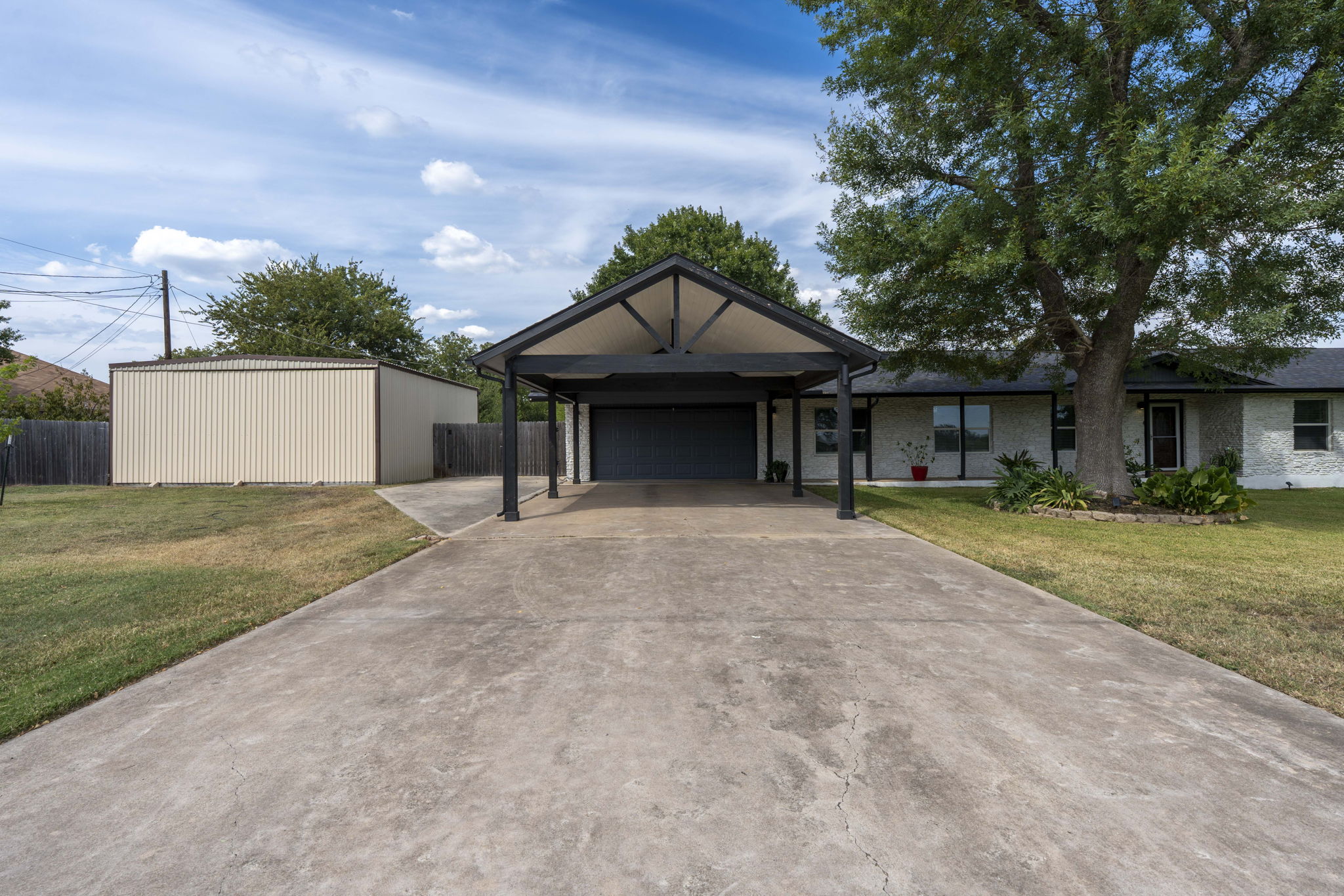 130 Hy Road Buda, TX 78610 - Photo 4 of 32 Ranch-style house with carport, and 20x25 metal building