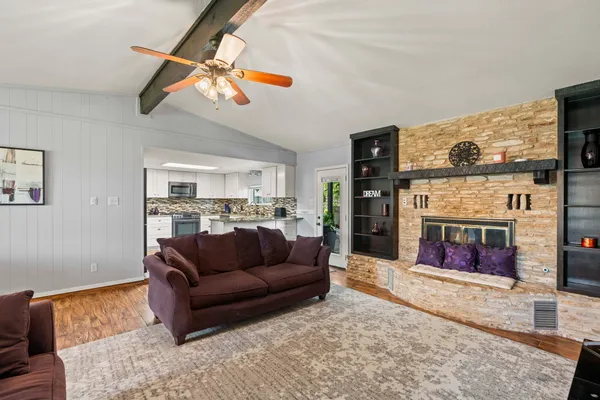 a living room with fireplace furniture and a flat screen tv