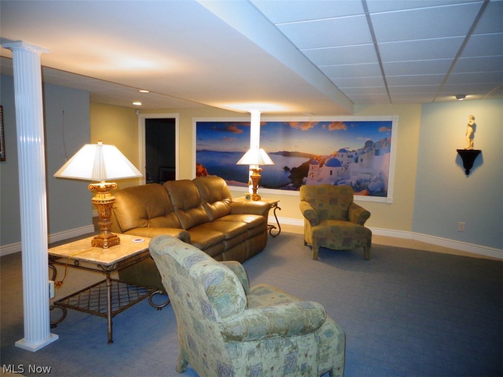 4158 Berkley Road Vermilion, OH 44089 - Photo 22 of 29 GORGEOUS 28x20 Family/Media room in the basement with vinyl decorative Greek columns and custom seamed carpet. The sellers said the framed mural can easily be removed if a buyer doesn't want it.