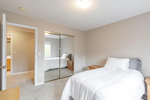 a bedroom with a bed and a potted plant