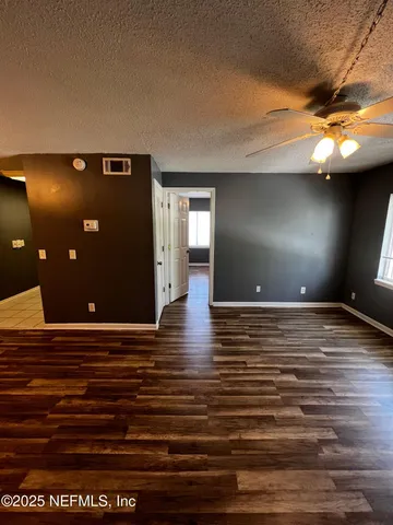a kitchen with granite countertop a sink a stove and cabinets