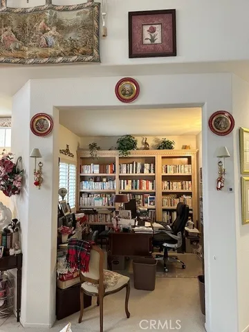 a view of a workspace with furniture and a window