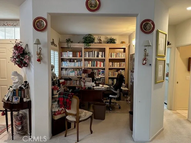 a bedroom with furniture and a large window