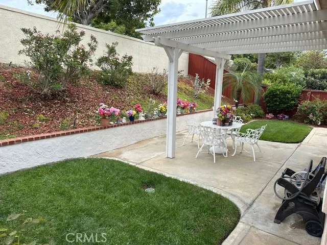 a view of a chairs and table in backyard of the house