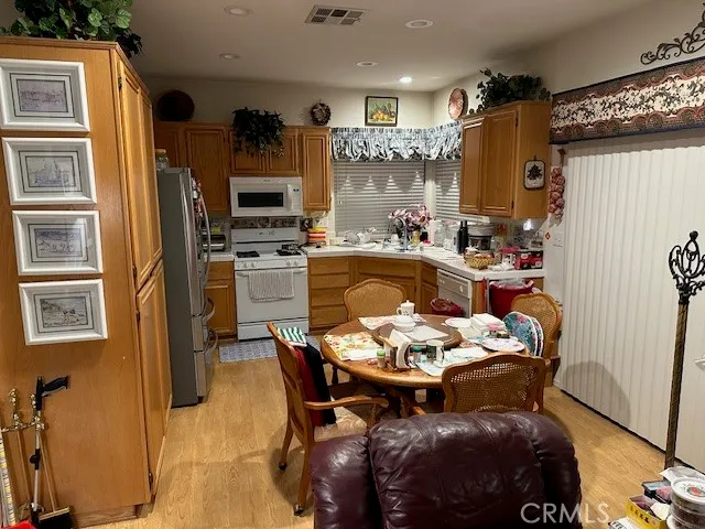 a dining room with furniture and kitchen view
