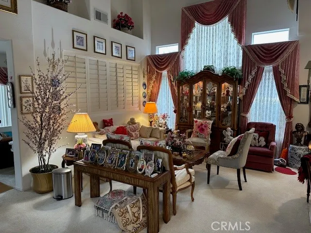 a living room with furniture a rug and a chandelier