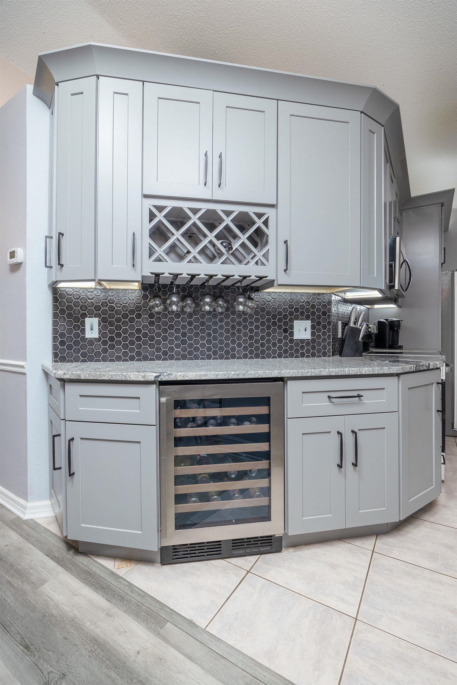 5 Rippling Place Palm Coast, FL 32164 - Photo 13 of 50 Indoor dry bar with gray cabinets, light stone counters, beverage cooler, and decorative backsplash