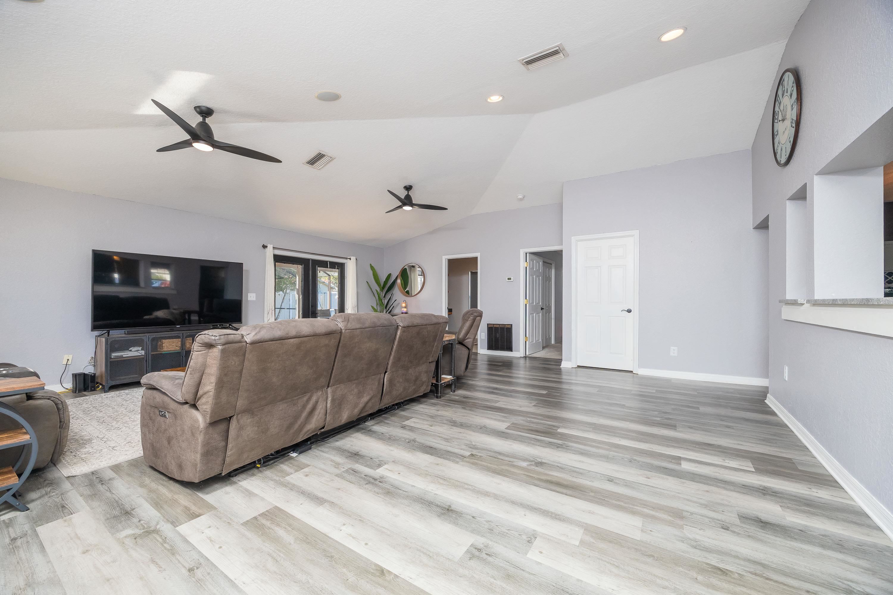 5 Rippling Place Palm Coast, FL 32164 - Photo 20 of 50 Living area with lofted ceiling, a ceiling fan, light wood finished floors, and recessed lighting