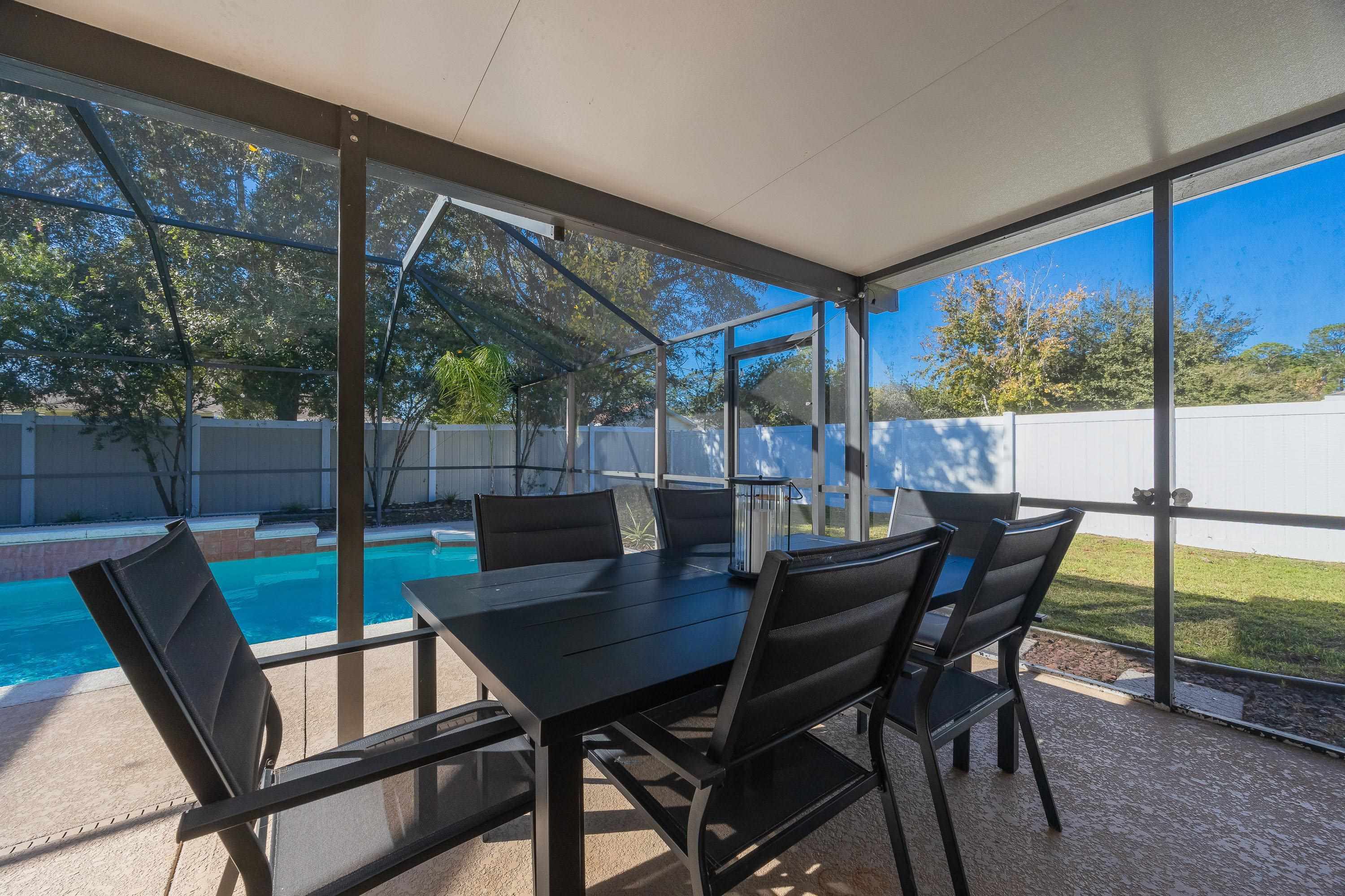 5 Rippling Place Palm Coast, FL 32164 - Photo 27 of 50 Sunroom with a patio area, outdoor dining area, and healthy amount of natural light