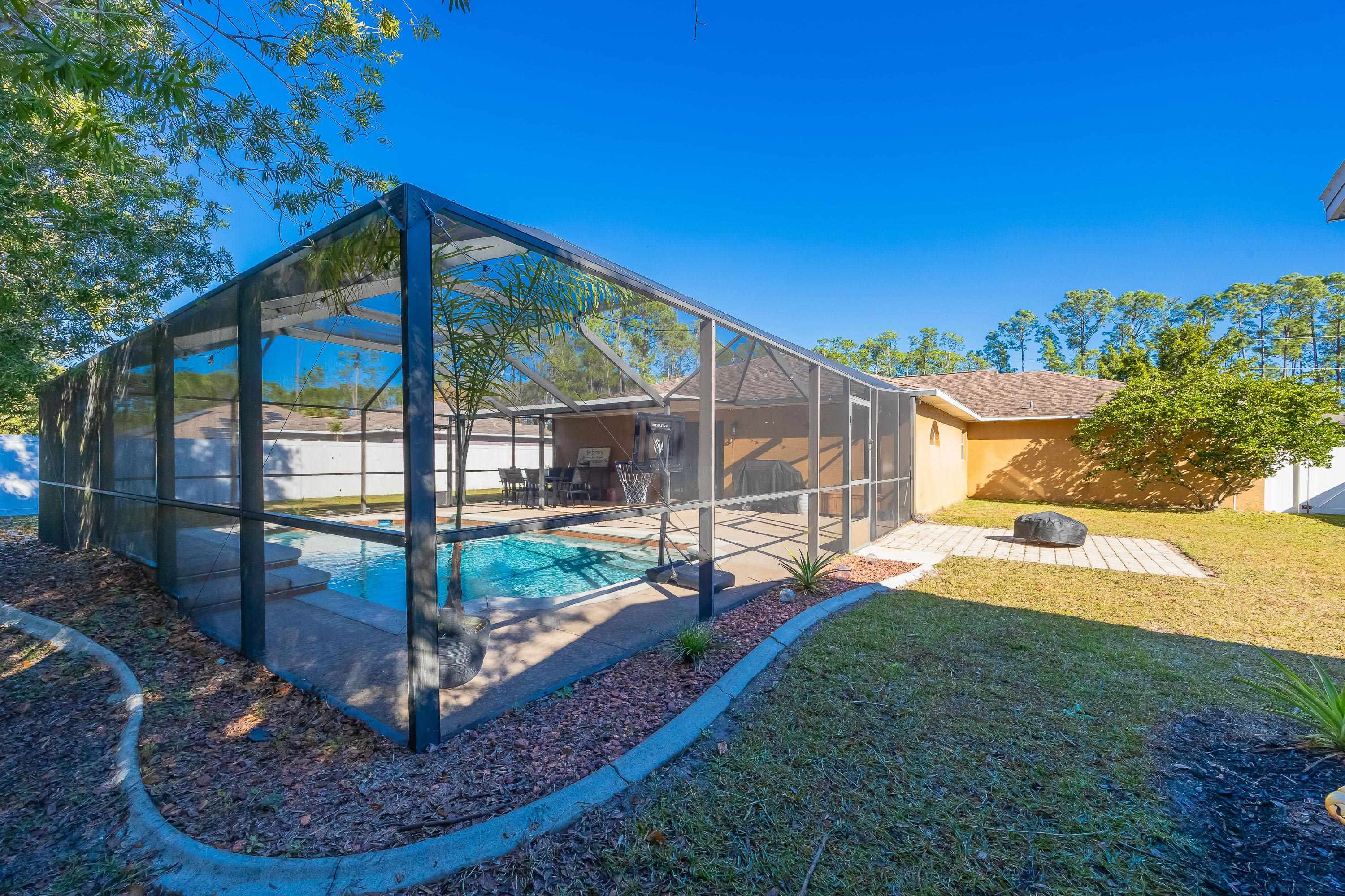 5 Rippling Place Palm Coast, FL 32164 - Photo 30 of 50 View of pool featuring a sunroom, a fenced backyard, a lanai, and a patio