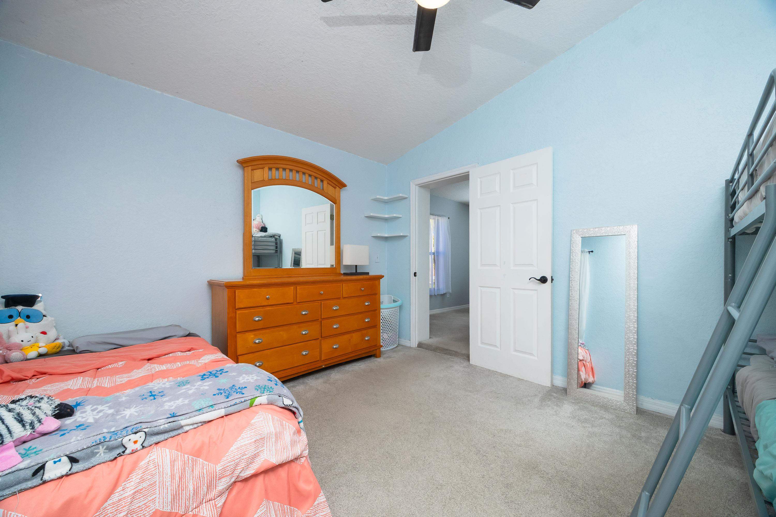 5 Rippling Place Palm Coast, FL 32164 - Photo 34 of 50 Bedroom featuring vaulted ceiling, light carpet, and a ceiling fan