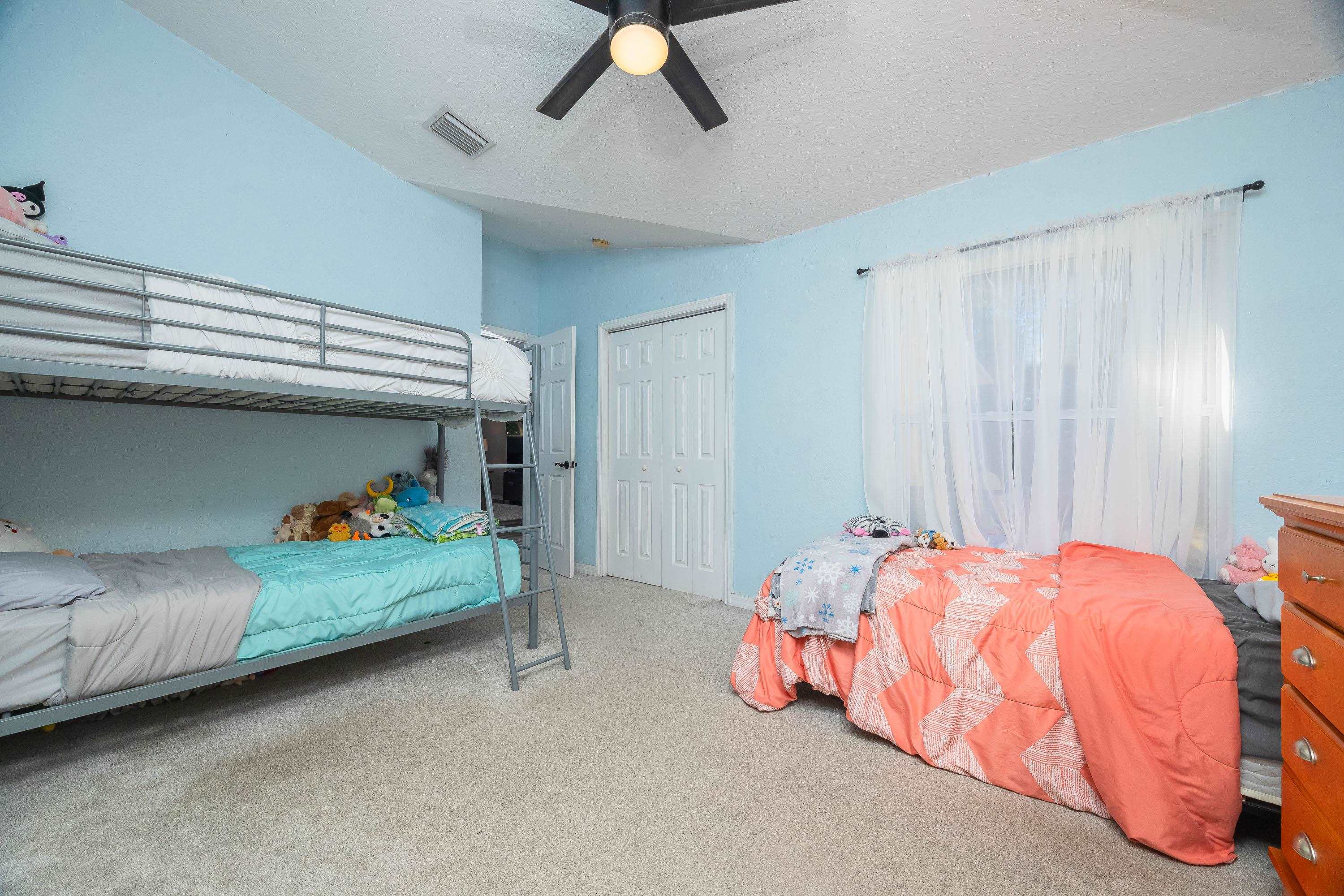 5 Rippling Place Palm Coast, FL 32164 - Photo 36 of 50 Bedroom featuring carpet flooring, ceiling fan, a textured ceiling, and a closet
