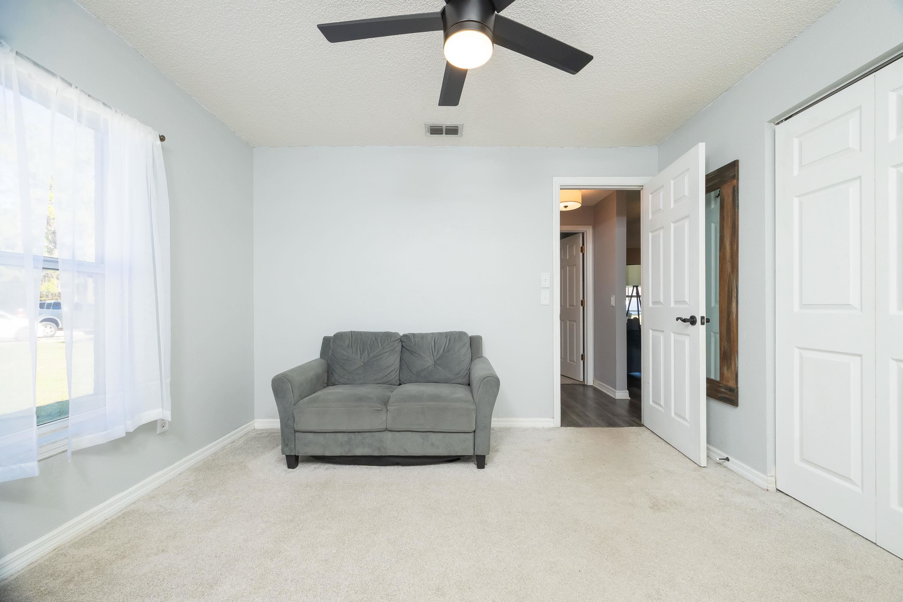 5 Rippling Place Palm Coast, FL 32164 - Photo 37 of 50 Living area with carpet flooring, a textured ceiling, and ceiling fan