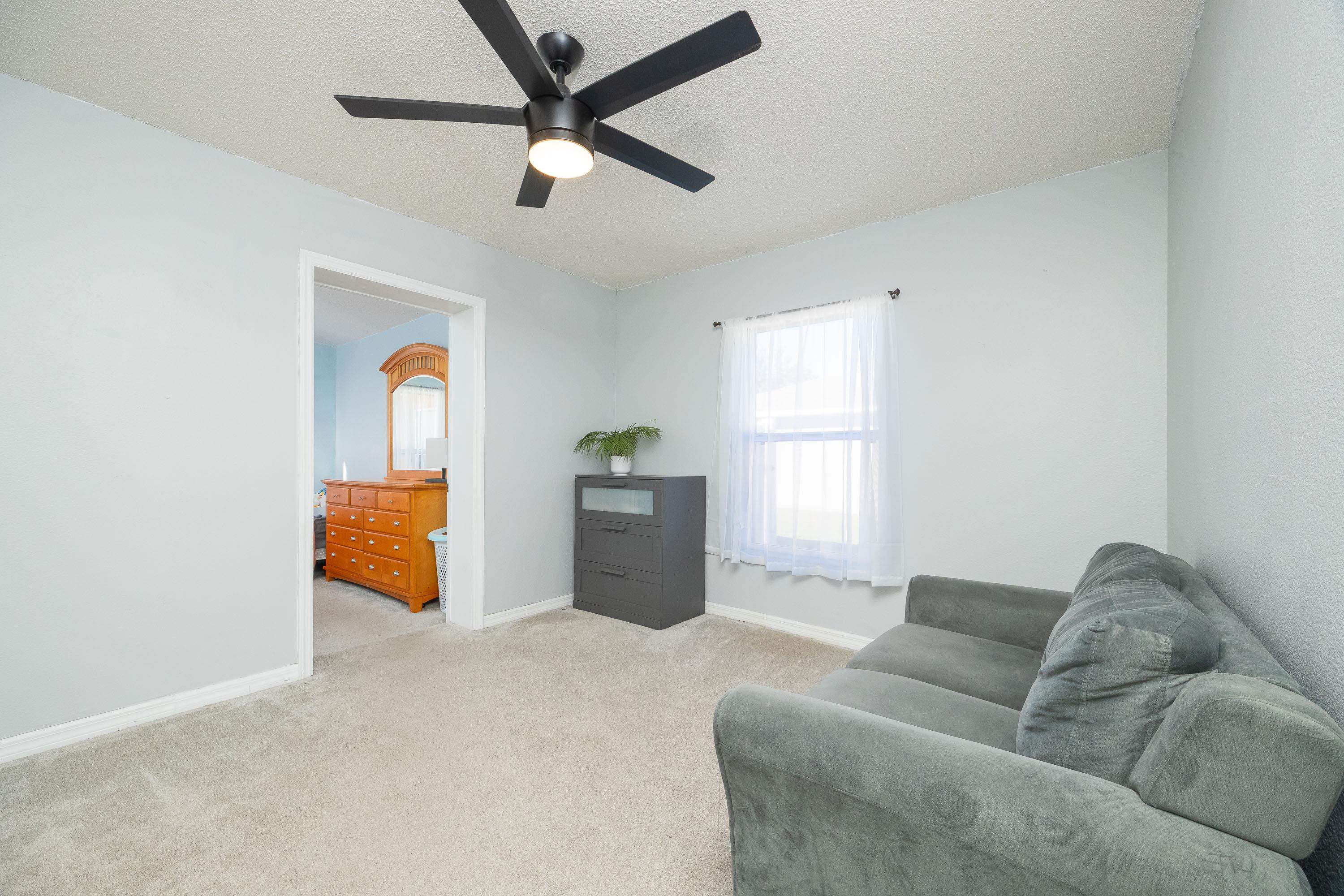 5 Rippling Place Palm Coast, FL 32164 - Photo 38 of 50 Sitting room with light colored carpet, a textured ceiling, and a ceiling fan