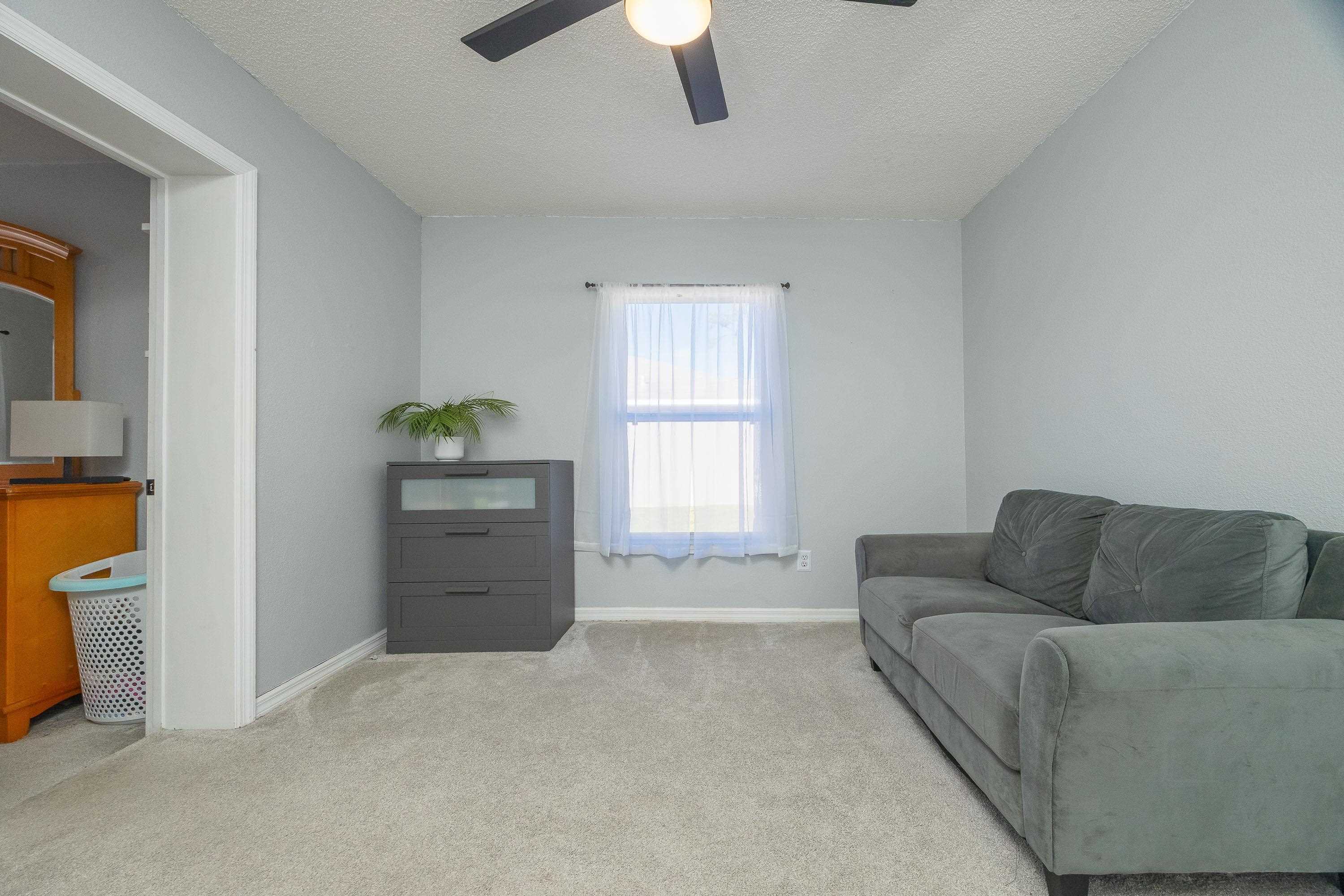 5 Rippling Place Palm Coast, FL 32164 - Photo 39 of 50 Living area with a textured ceiling, carpet floors, and a ceiling fan