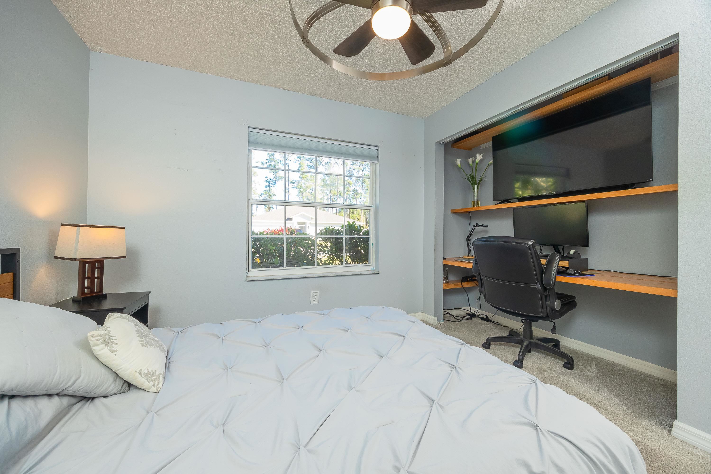 5 Rippling Place Palm Coast, FL 32164 - Photo 43 of 50 Carpeted bedroom with a textured ceiling, ceiling fan, and built in study area