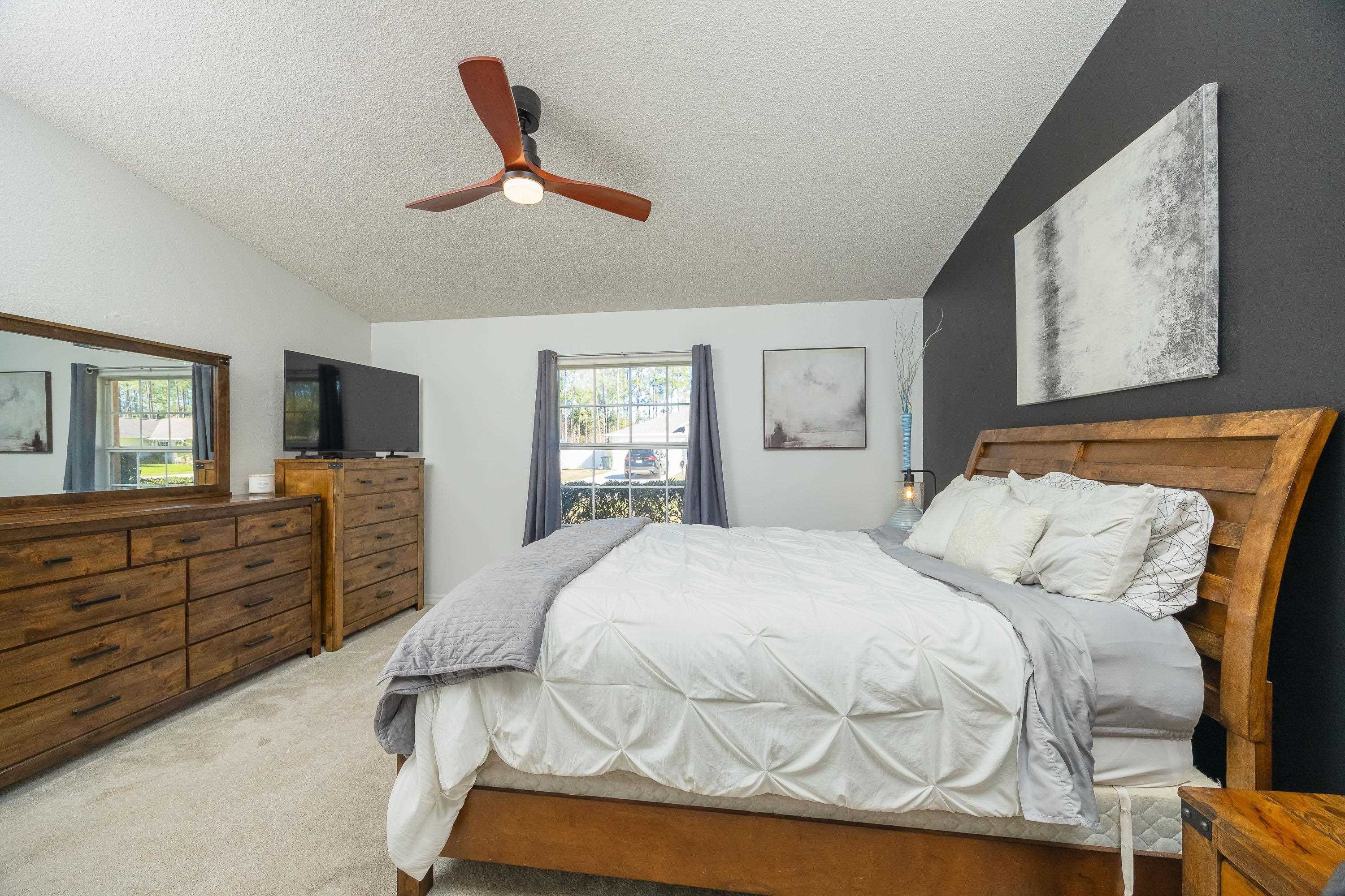 5 Rippling Place Palm Coast, FL 32164 - Photo 46 of 50 Bedroom featuring carpet floors, a textured ceiling, ceiling fan, and vaulted ceiling