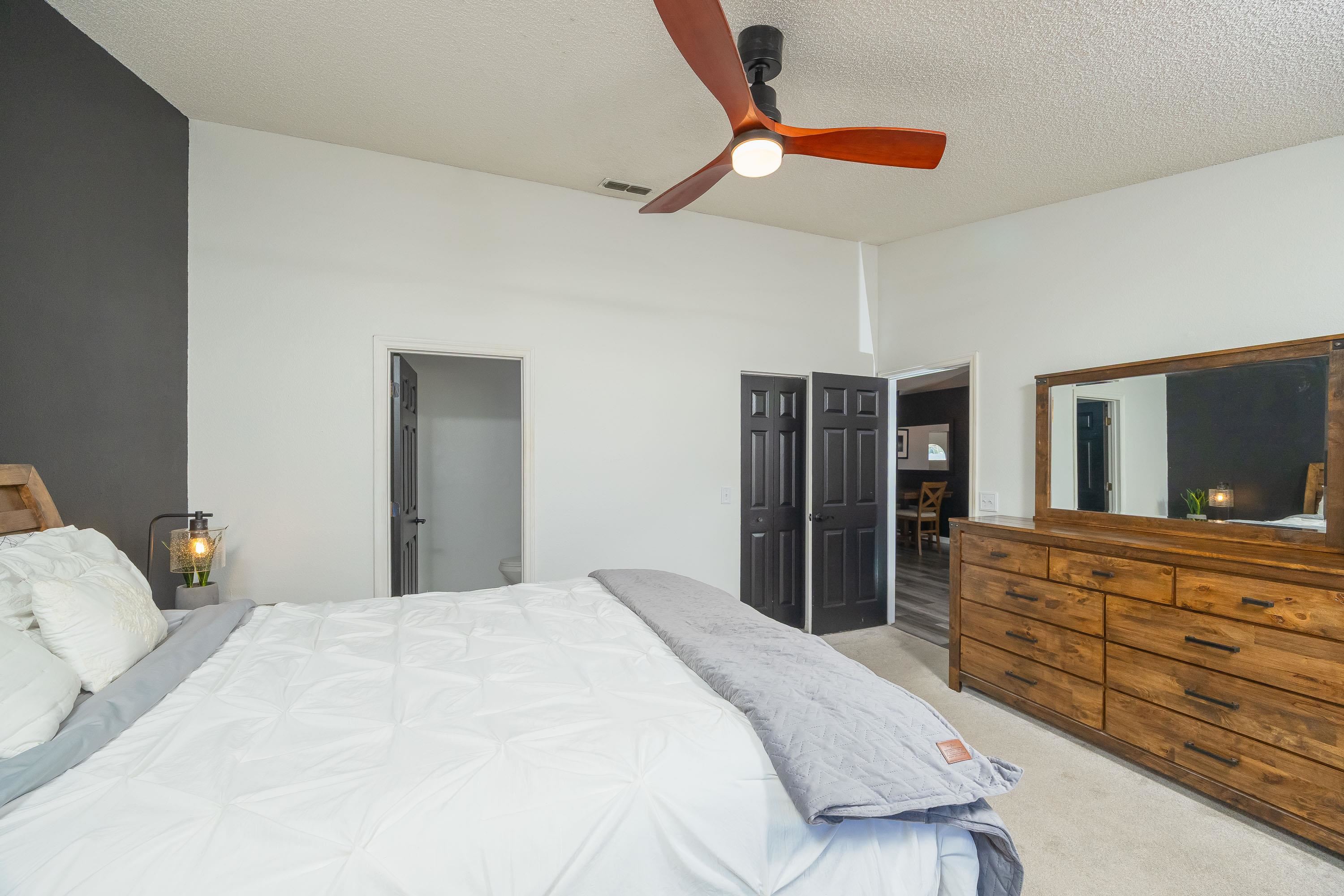 5 Rippling Place Palm Coast, FL 32164 - Photo 47 of 50 Bedroom with light colored carpet, a ceiling fan, a textured ceiling, and ensuite bathroom