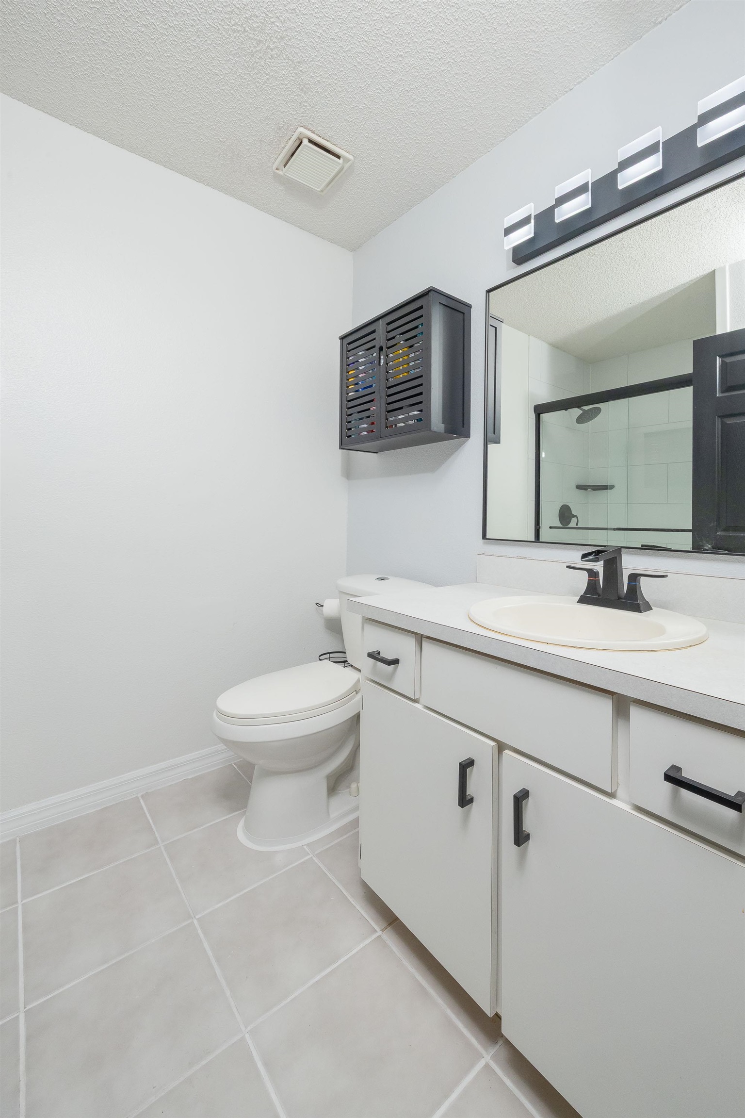 5 Rippling Place Palm Coast, FL 32164 - Photo 48 of 50 Full bath featuring a textured ceiling, vanity, a shower stall, and light tile patterned floors