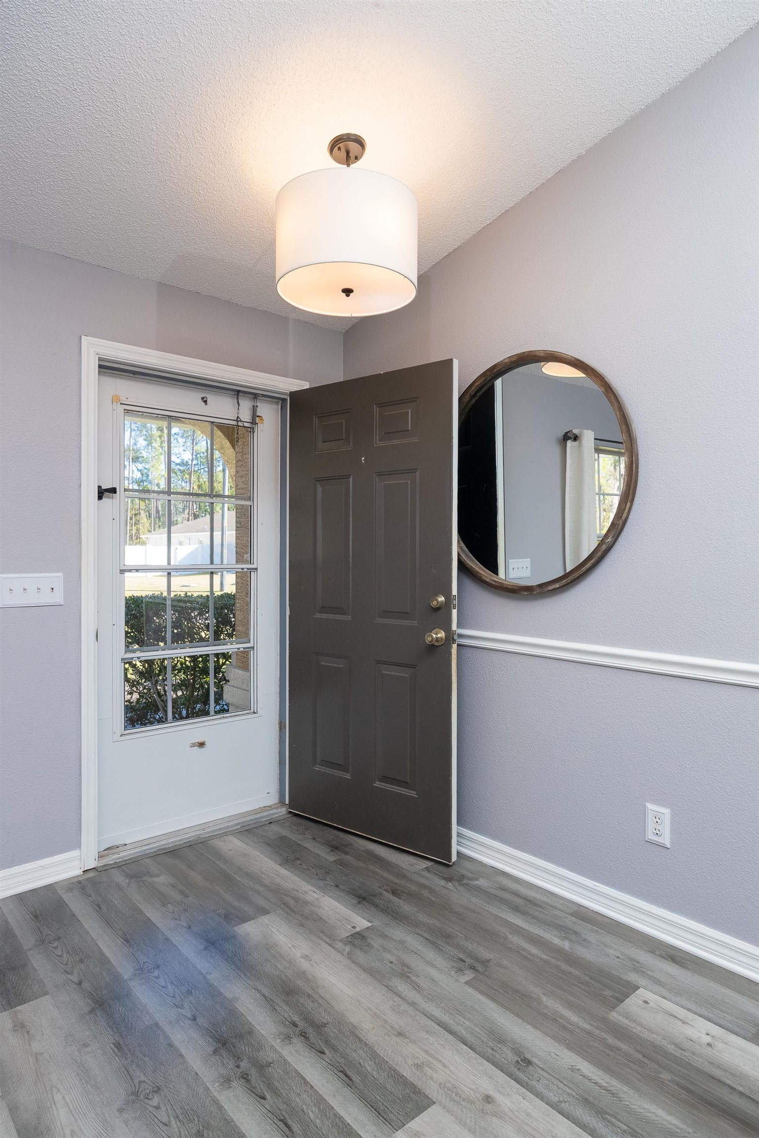 5 Rippling Place Palm Coast, FL 32164 - Photo 7 of 50 Entrance foyer with a textured ceiling and wood finished floors