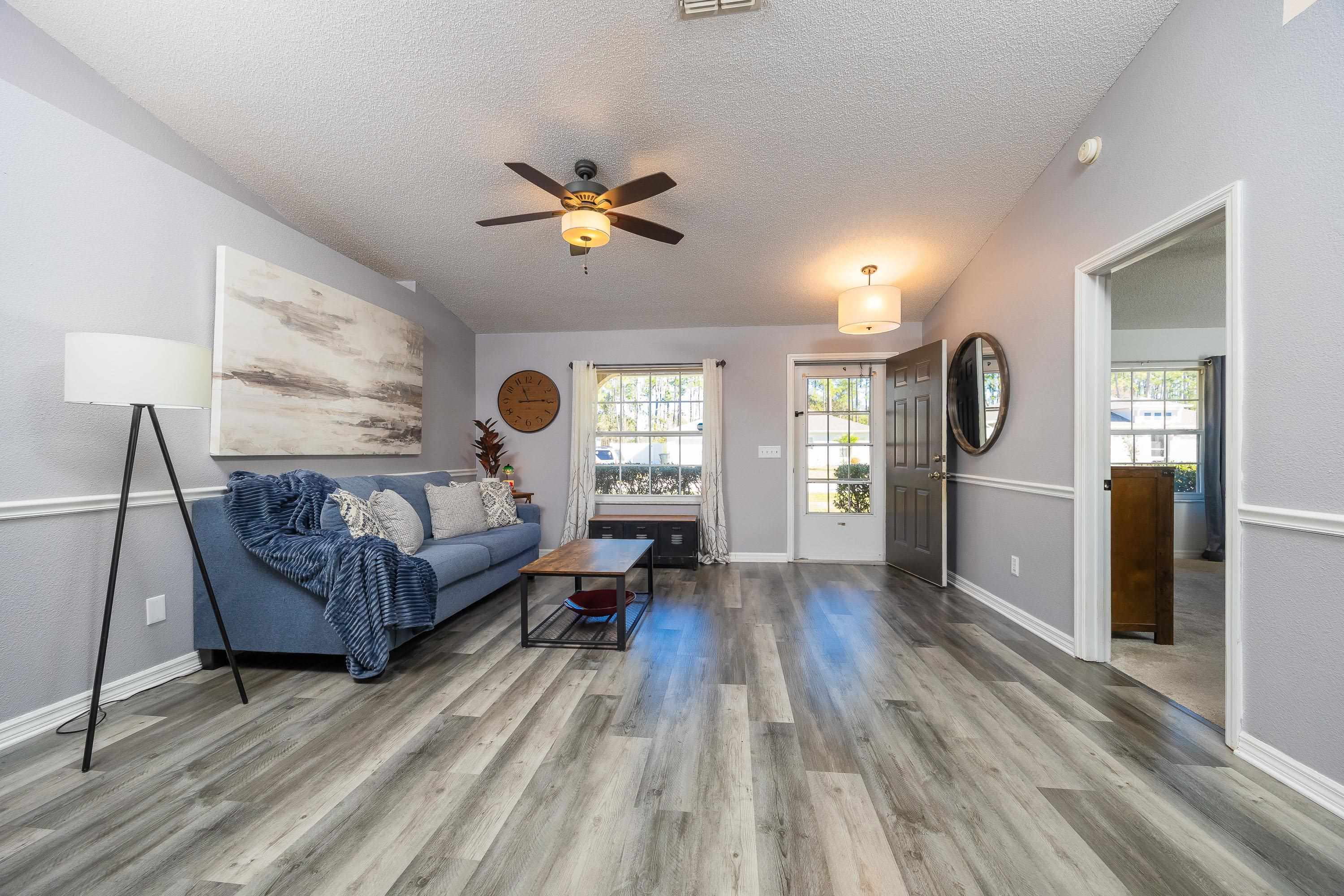 5 Rippling Place Palm Coast, FL 32164 - Photo 8 of 50 Living area with ceiling fan, light wood finished floors, and a textured ceiling