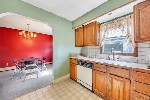 a kitchen with stainless steel appliances granite countertop sink stove and white cabinets