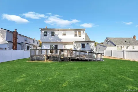 a view of a house with a yard and sitting area