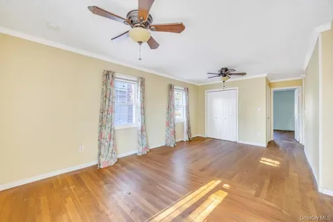 a bedroom with a large bed and ceiling fan