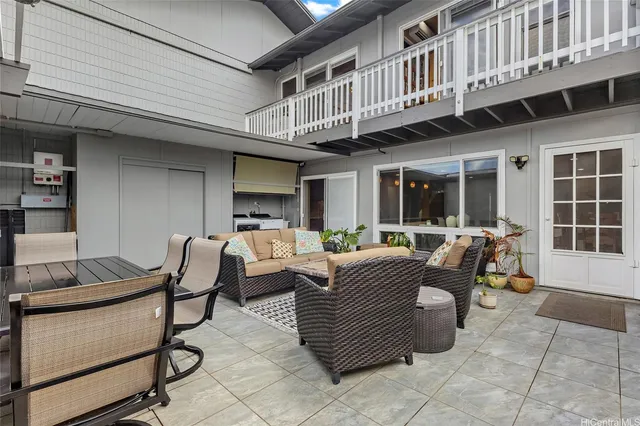 a view of a patio with dining table and chairs and potted plants