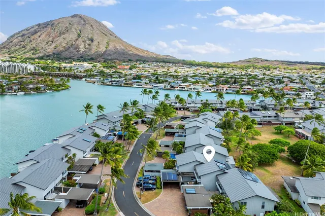 an aerial view of residential houses with outdoor space and lake view